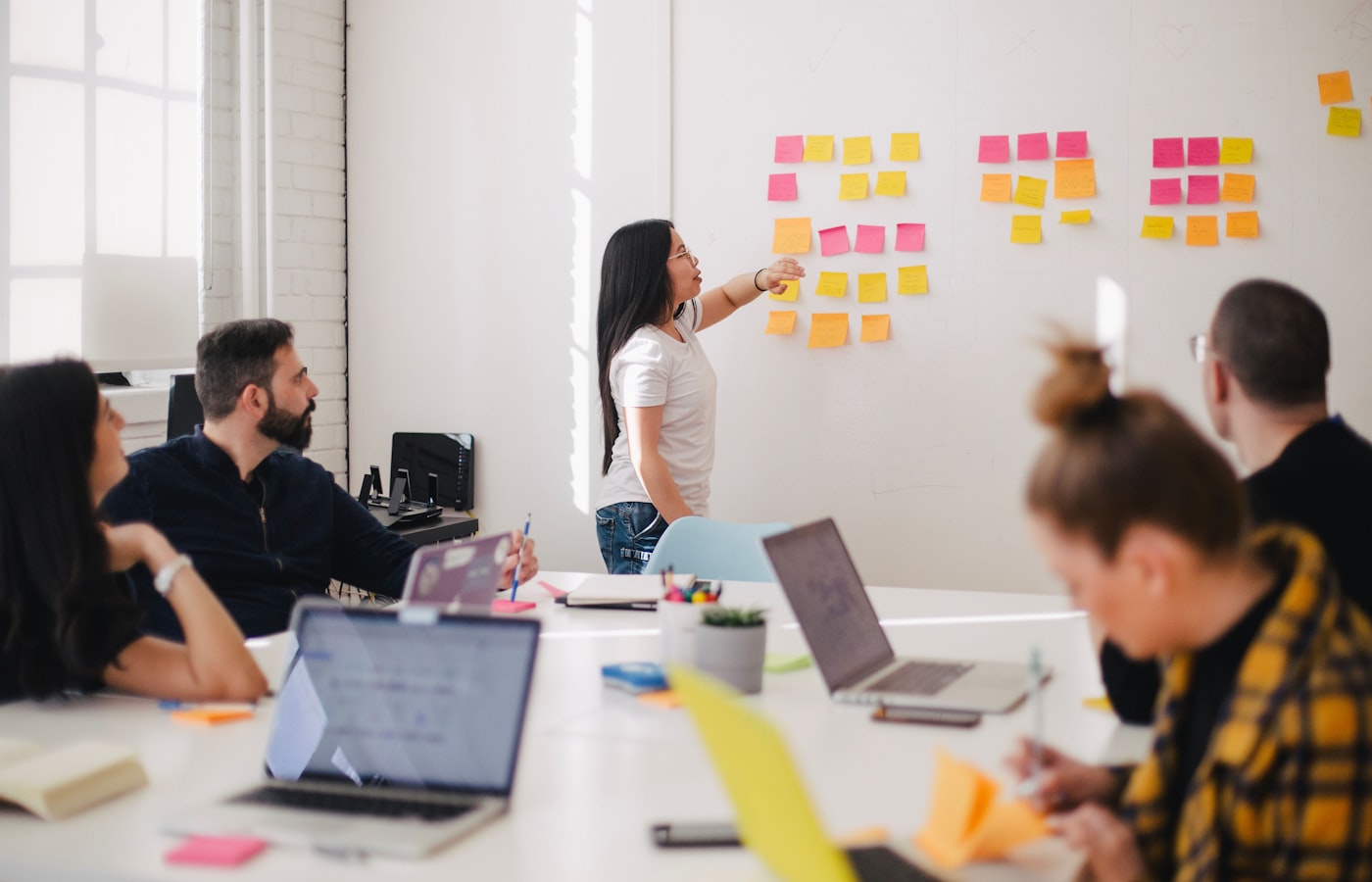 Remote team collaborating around sticky notes in a workshop